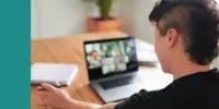 A person taking notes while in an online meeting