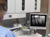 Dental nurse assists with routine patient exam