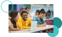 A row of smiling college students looking at a laptop